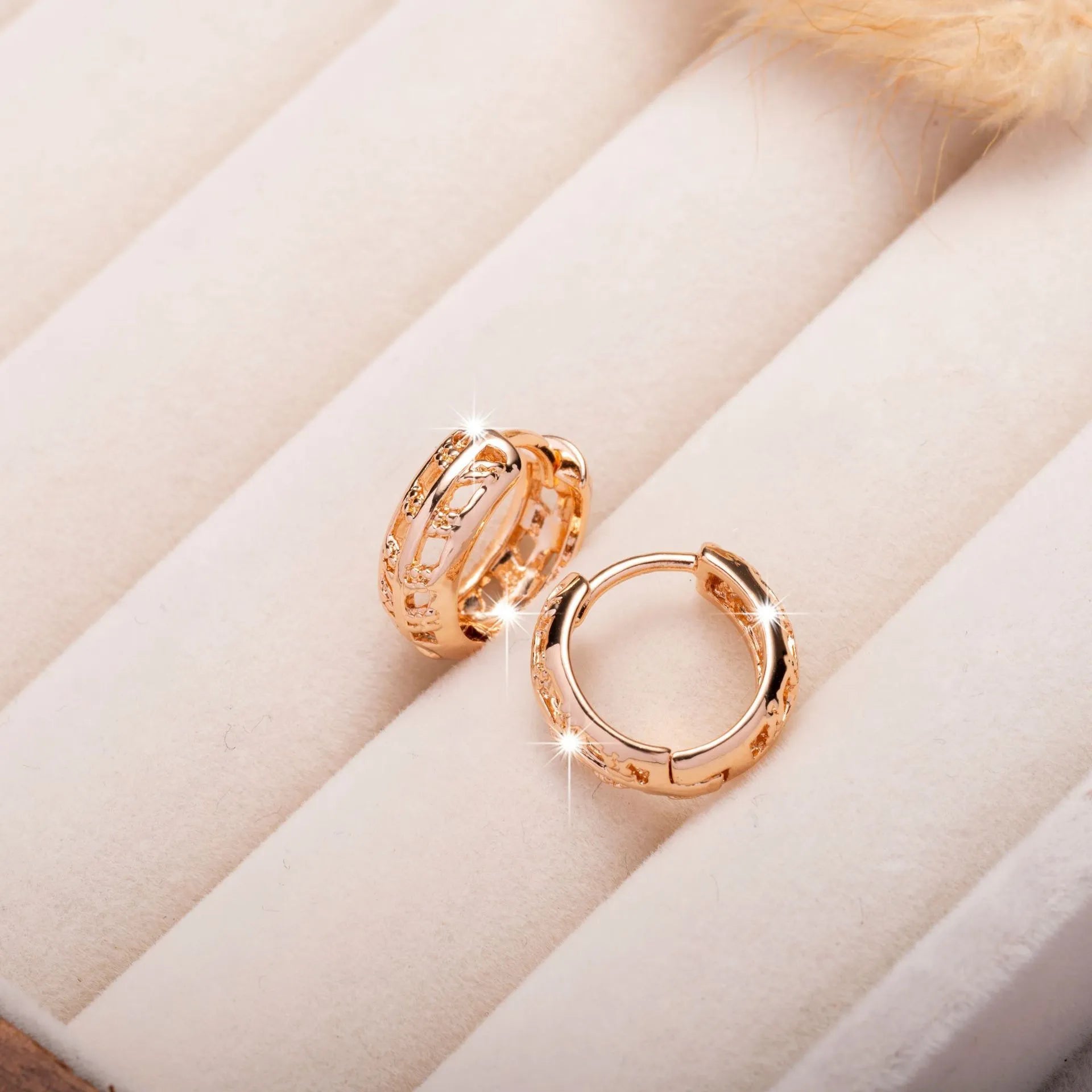 Close-up of rose gold hollowed-out heart and leaf drop earrings showing intricate open metalwork and 2.8cm length.