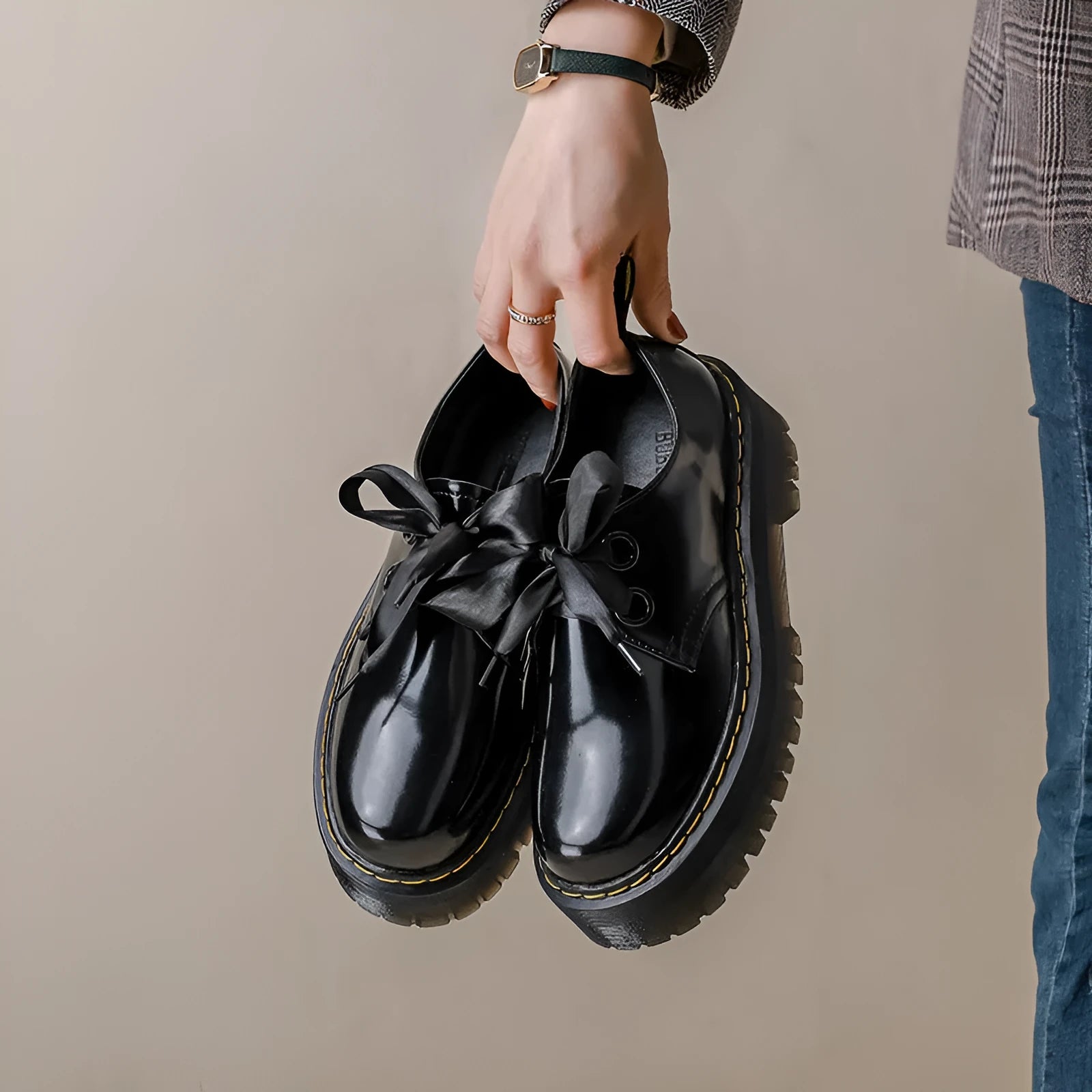 Women's white and black thick soled lace-up shoes with ribbon cross-straps on a superfine fibre upper.