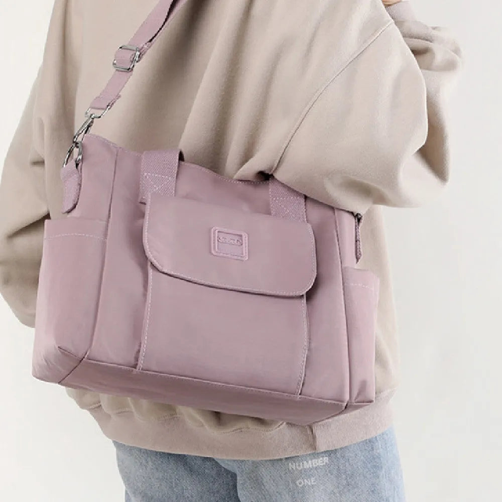 Nylon multi-interlayer shoulder bag in black with single strap and outer sandwich pocket, horizontal square shape