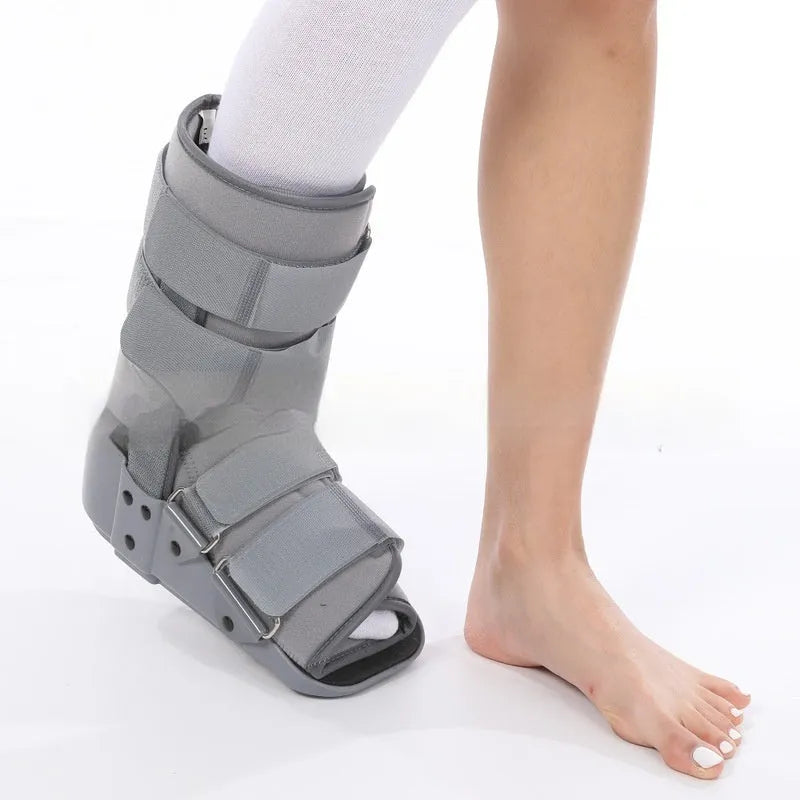 Grey Achilles tendon rehabilitation boot with fixed support and walking shoe sole.