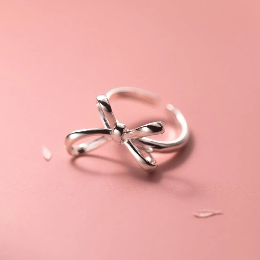S925 silver bow ring with adjustable open band on hand, showing polished finish and Korean style design
