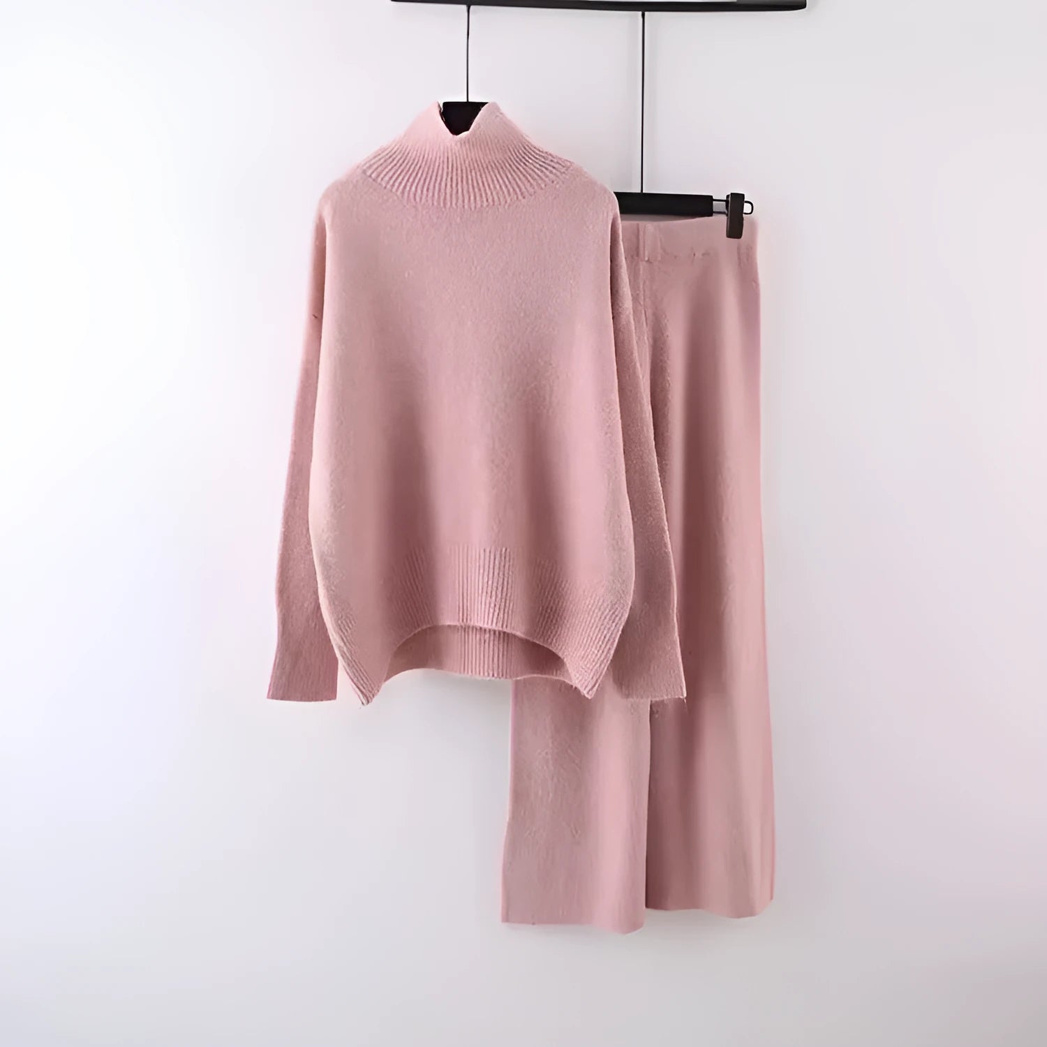 Women's milky white acrylic knit sweater and wide-leg trouser two-piece set on a hanger.