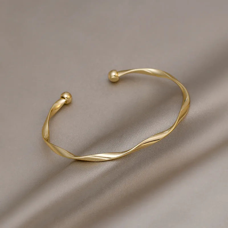 Gold twisted alloy bracelet with geometric Korean style design and 6.2cm inner ring diameter