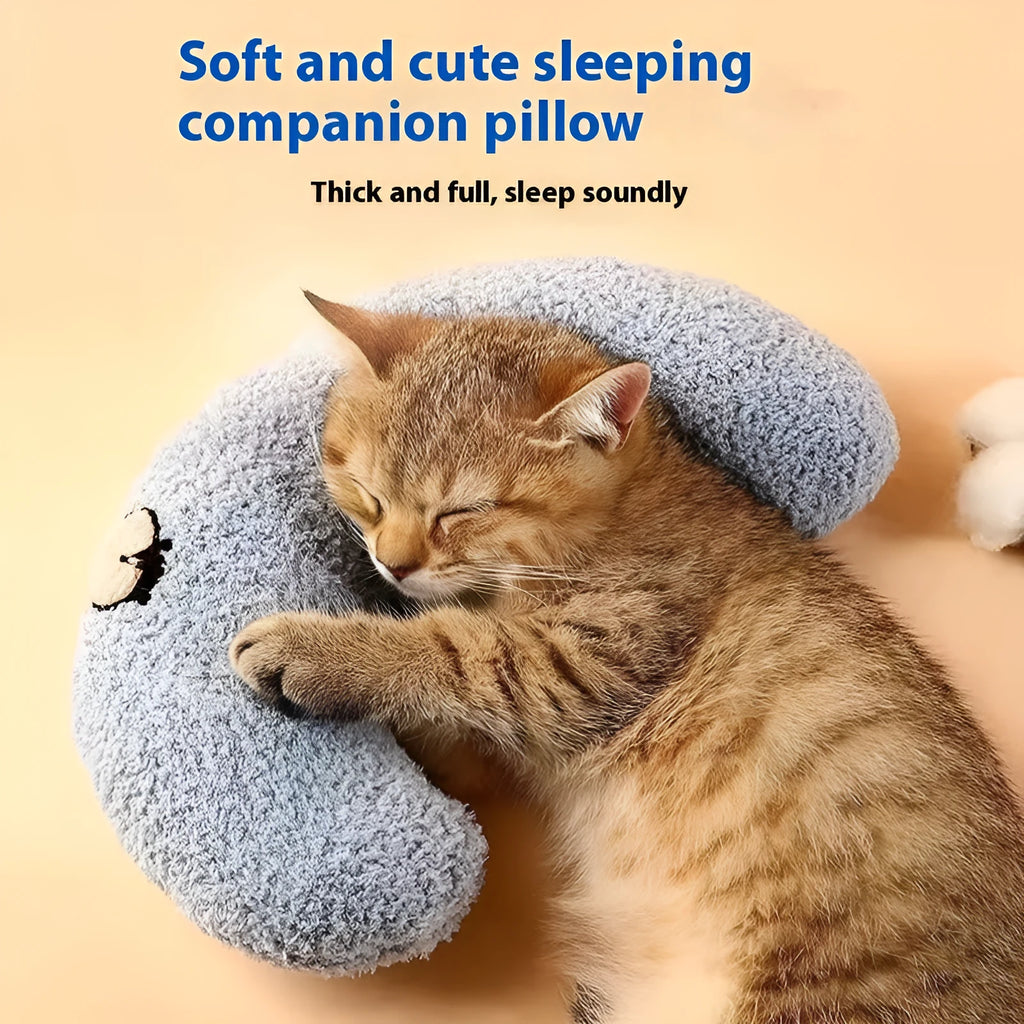 Blue and yellow question mark shaped cat bed with a built-in U-shaped neck support pillow on a wooden floor.