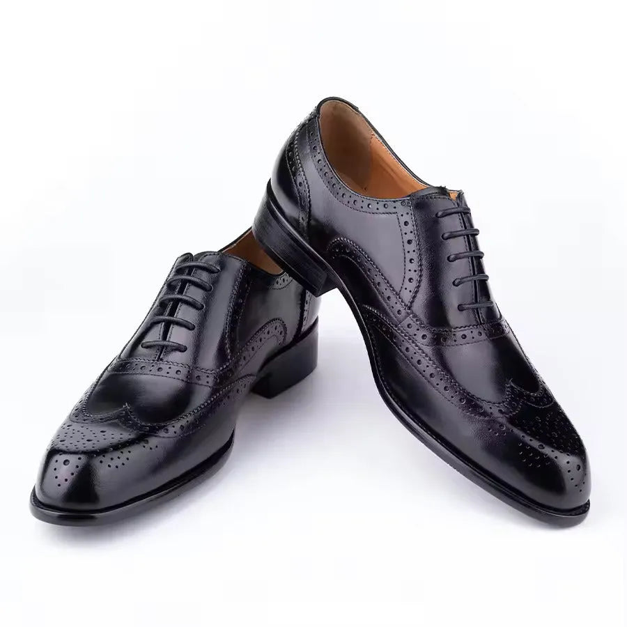 Men's purple leather Oxford dress shoes with hand-carved detailing and pointed toe on a rubber sole.