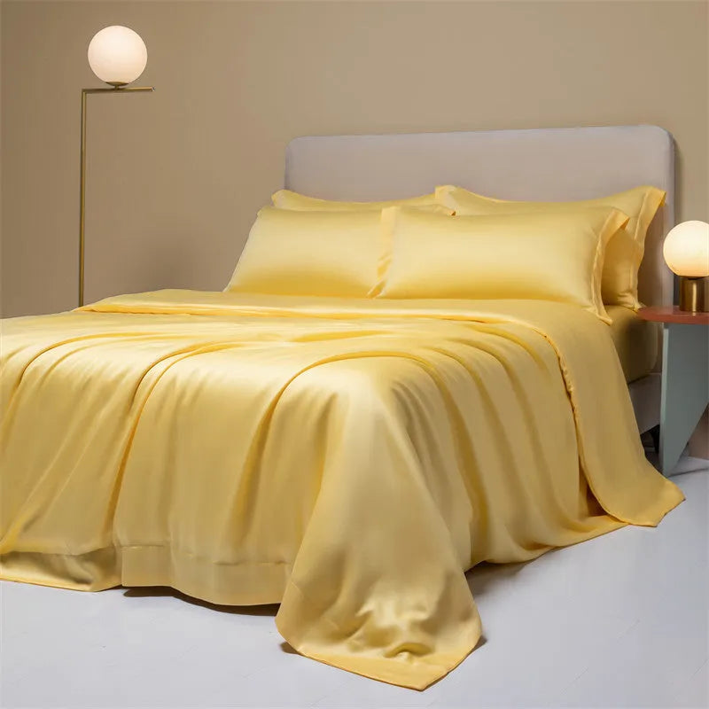 Aurora Blue 200 thread count Tencel duvet cover, fitted sheet, and pillowcases laid on a modern bed.