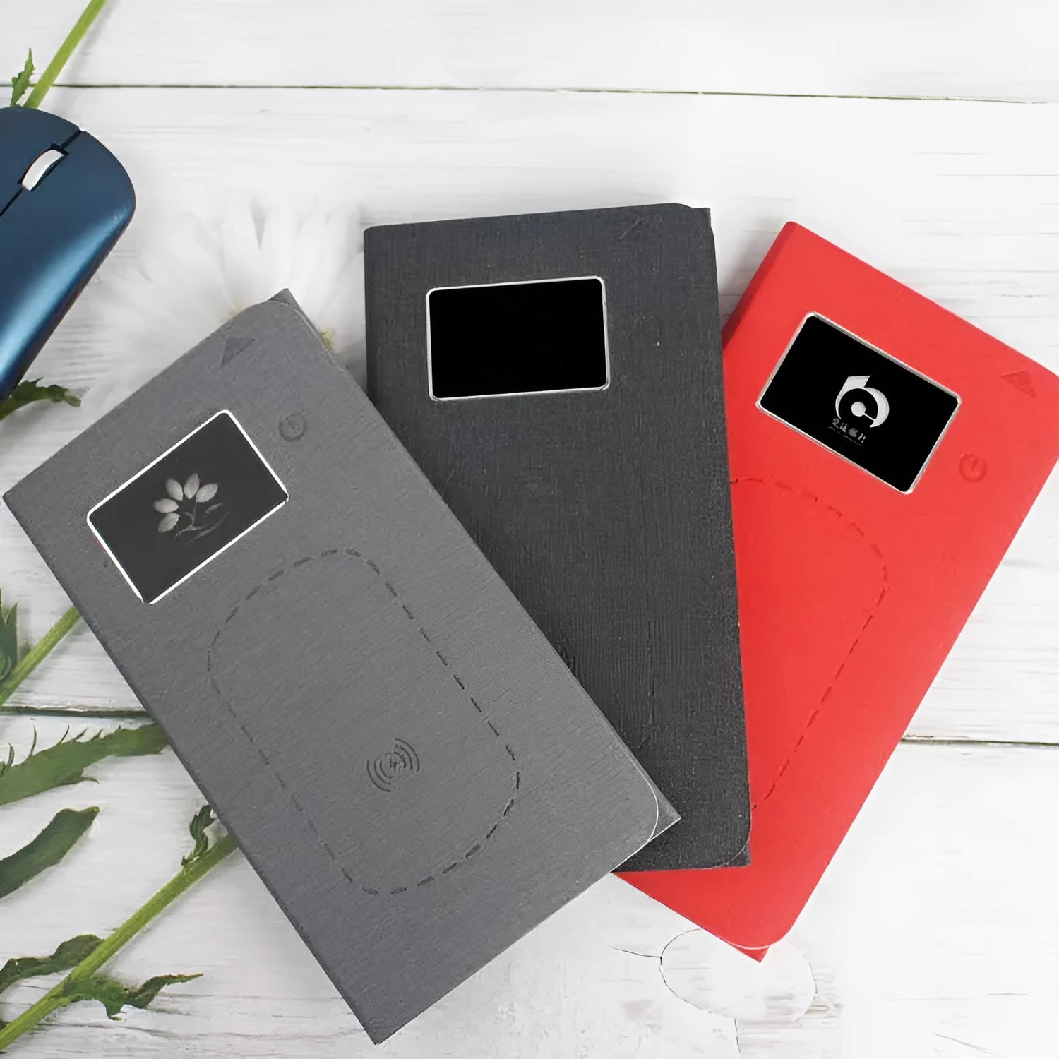 Folding wireless charging mouse pad set with compact wireless mouse on branded cloth surface.