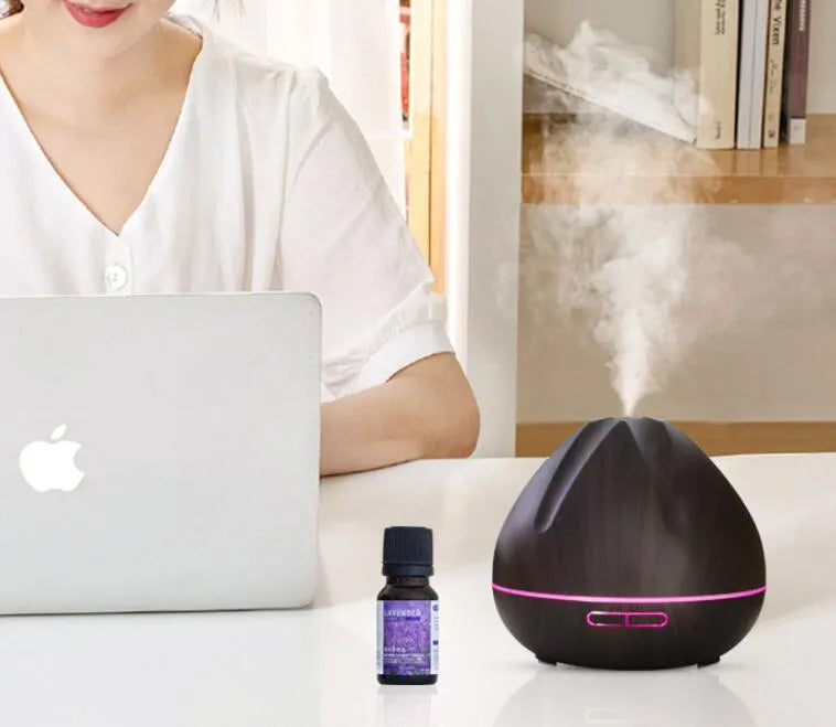 Air humidifier aromatherapy machine with 500ml capacity and light wood finish placed on a desk