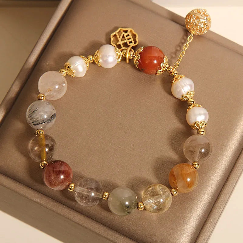 Women's Japanese-style crystal bracelet with pearls and Chinese 'Cai' character charm.