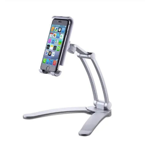 Silver aluminium alloy tablet stand with adjustable black clips holding a tablet, showing 360-degree rotation on a wooden desk.