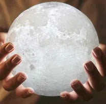 3D printed moon lamp on wooden stand showing detailed lunar surface, with touch ring at base.