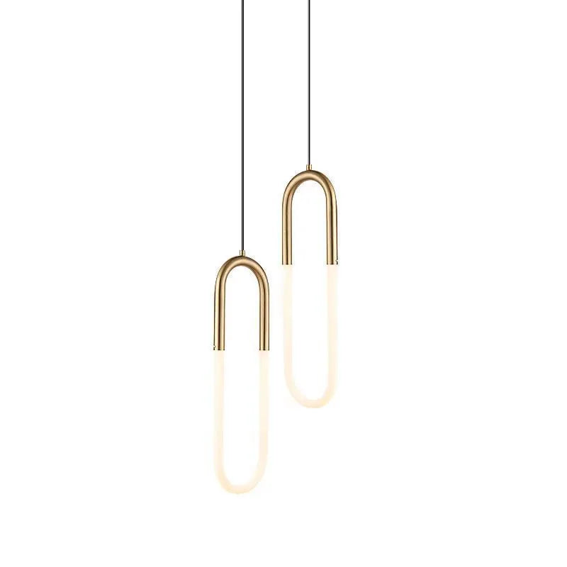 Compact Nordic minimalist U-shaped white pendant light with fabric cord, shown mounted beside a bed.