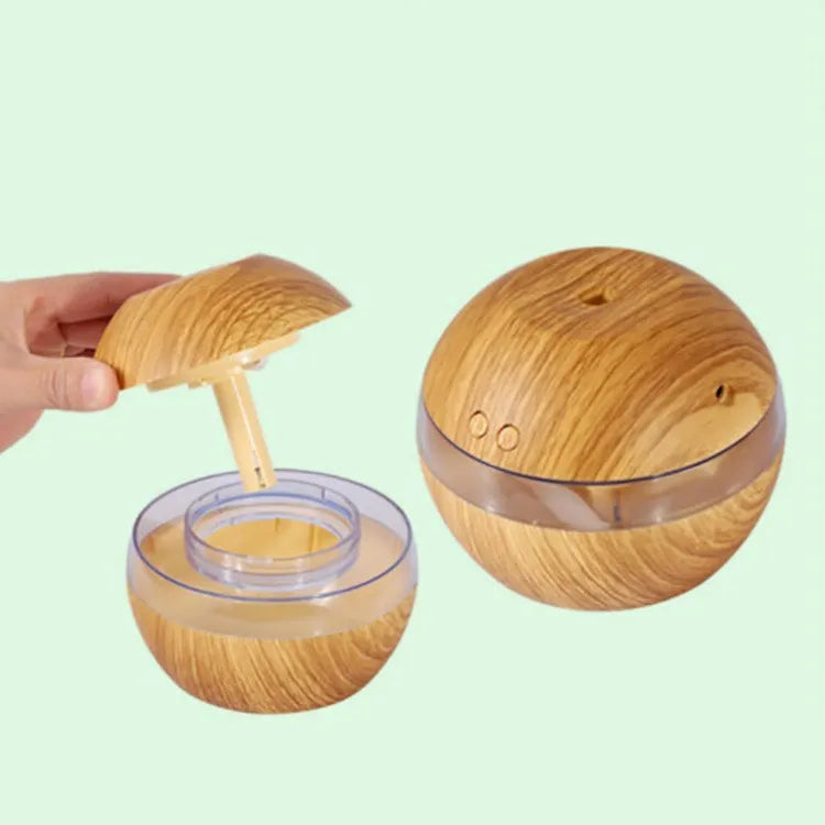 Compact brown wood grain USB humidifier with 200ml water tank on a desk.