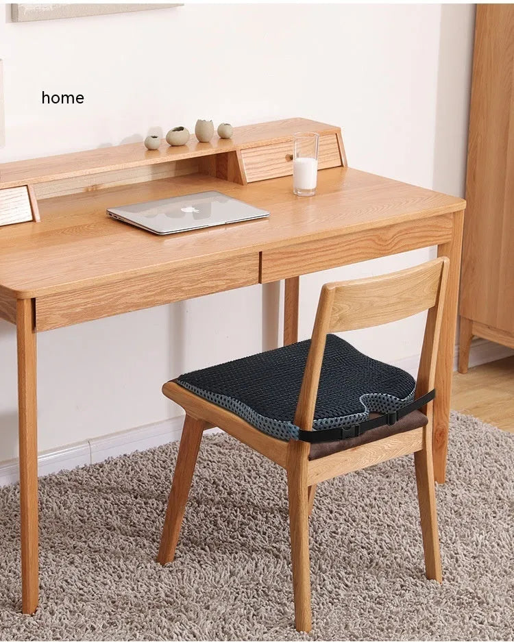 A solid-colour memory foam seat cushion with an adjustable strap, shown in creamy white.