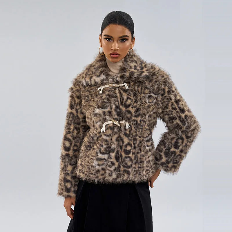 Women's leopard print coat with a buckle on the lapel collar, shown in street fashion style.