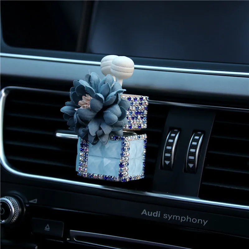 Car flower outlet perfume air freshener in white colour clipped to vehicle air vent, 3.2cm x 7cm size