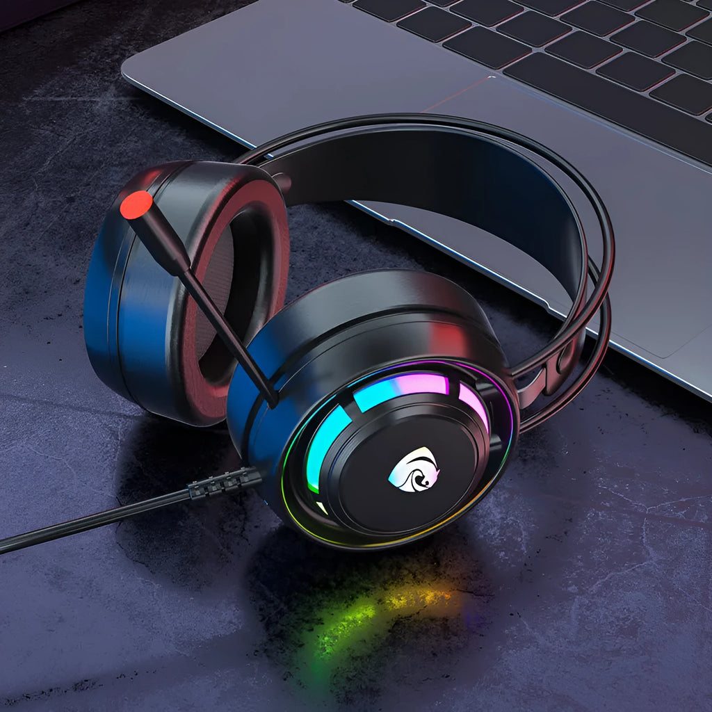 Black wired computer headphones with microphone, showing 3.5mm and USB plug options on a desk.