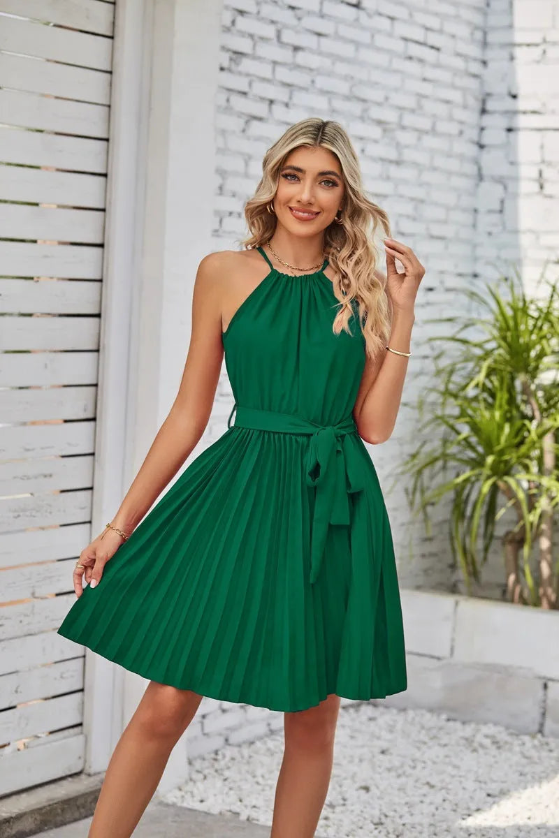 Women's black chiffon halter dress with pleated skirt and waist belt laid flat