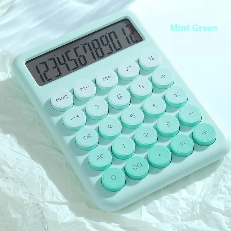 Gradient colour desktop calculator in violet, pink, blue, or green on a desk.