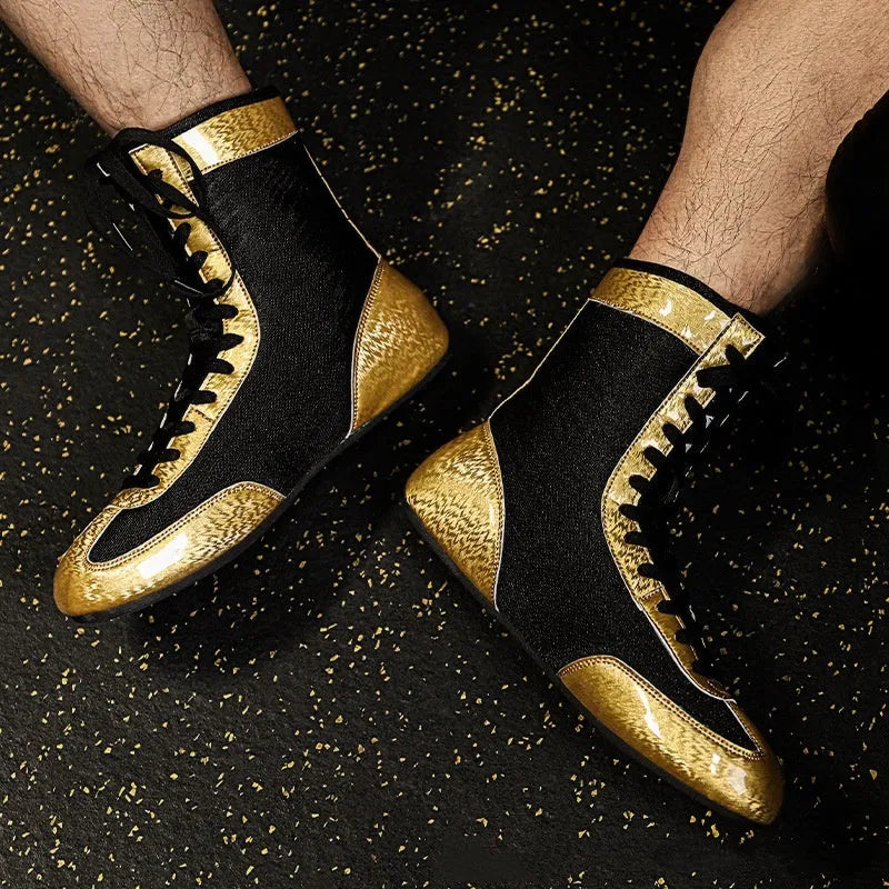 Professional black and gold mesh boxing shoes with a non-slip rubber sole for indoor training.