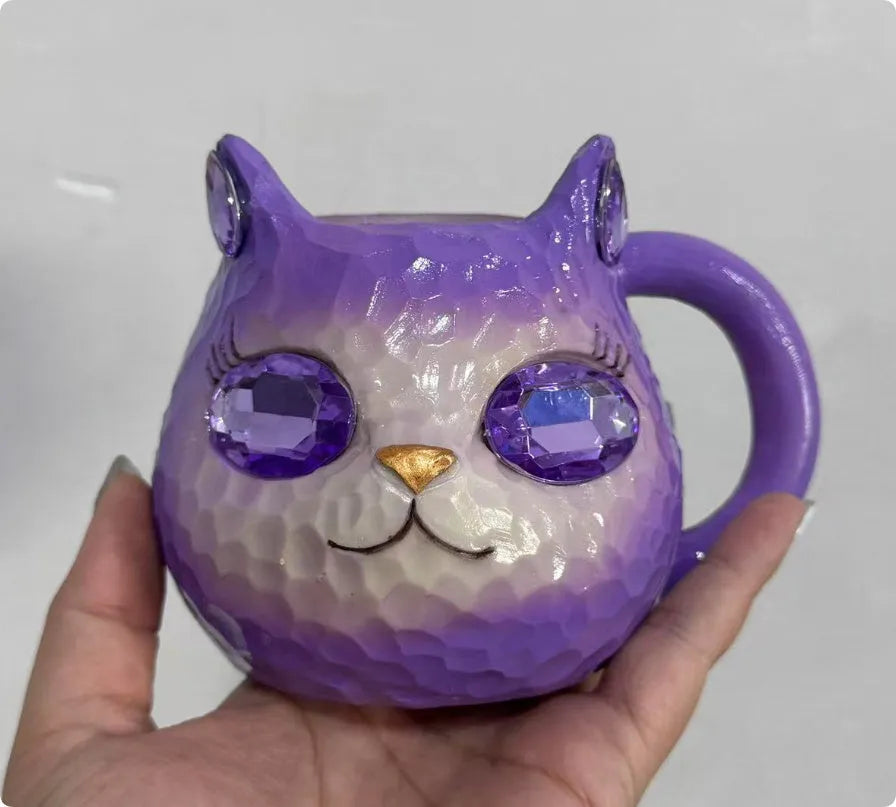 Resin cat cup ornament with crystal earth design in blue, green, pink, or purple colour options.