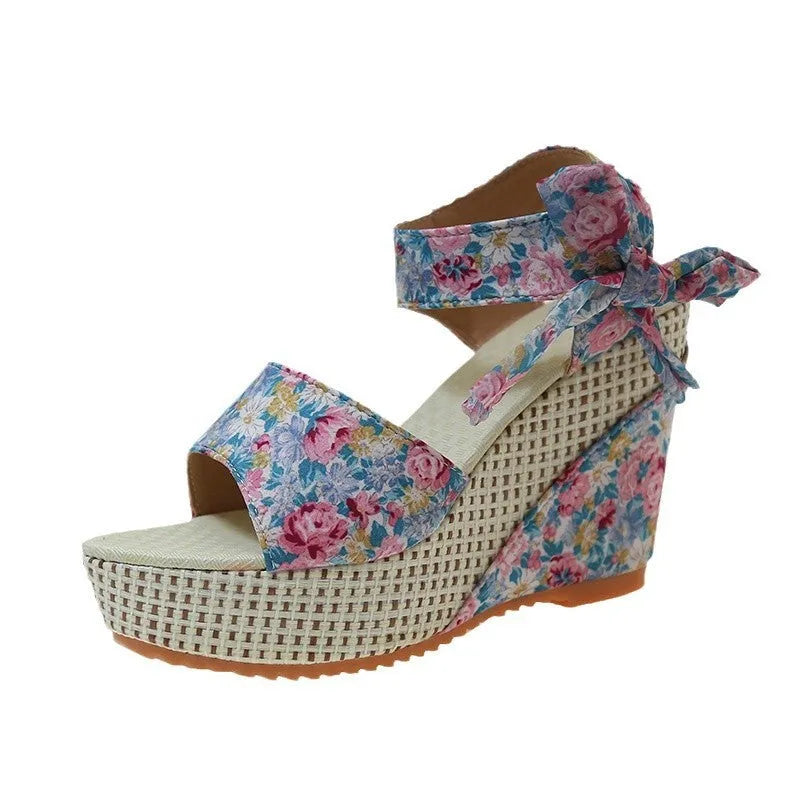 Women's floral wedge sandals with peep toe and ankle strap in pink, black, or blue.