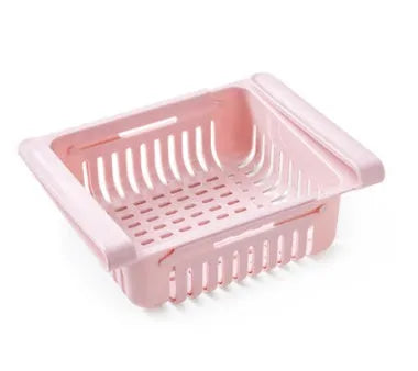 Blue telescopic plastic storage basket for refrigerator organisation with fruits and vegetables inside.