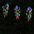 Three solar-powered garden lights with leaf branch design for lawn decoration