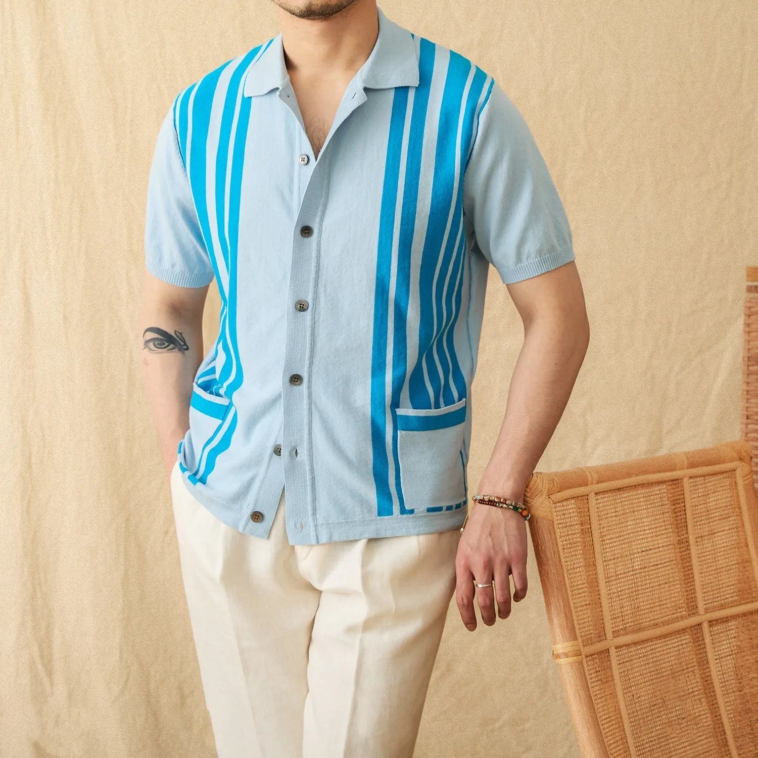 Short-sleeved striped knit polo cardigan with a lapel collar in a light blue colour.