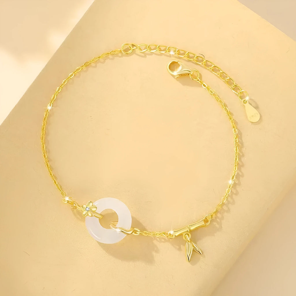 Silver bracelet with white chalcedony stone and starry sky patterned gold peace buckle.