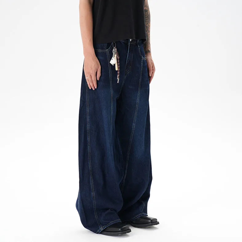 Dark blue washed distressed wide leg machete jeans showing denim fabric texture and wide leg silhouette