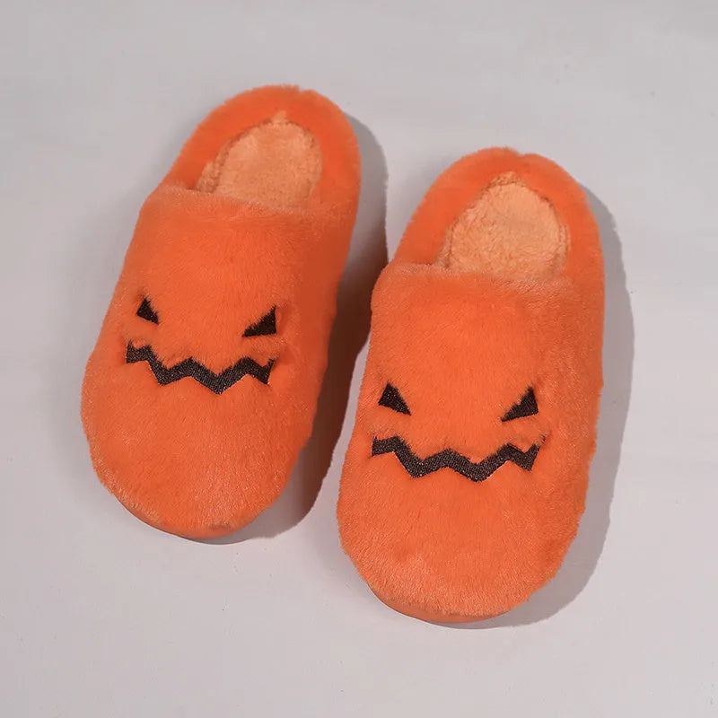Orange Halloween pumpkin-themed plush indoor slippers with a non-slip PVC sole.