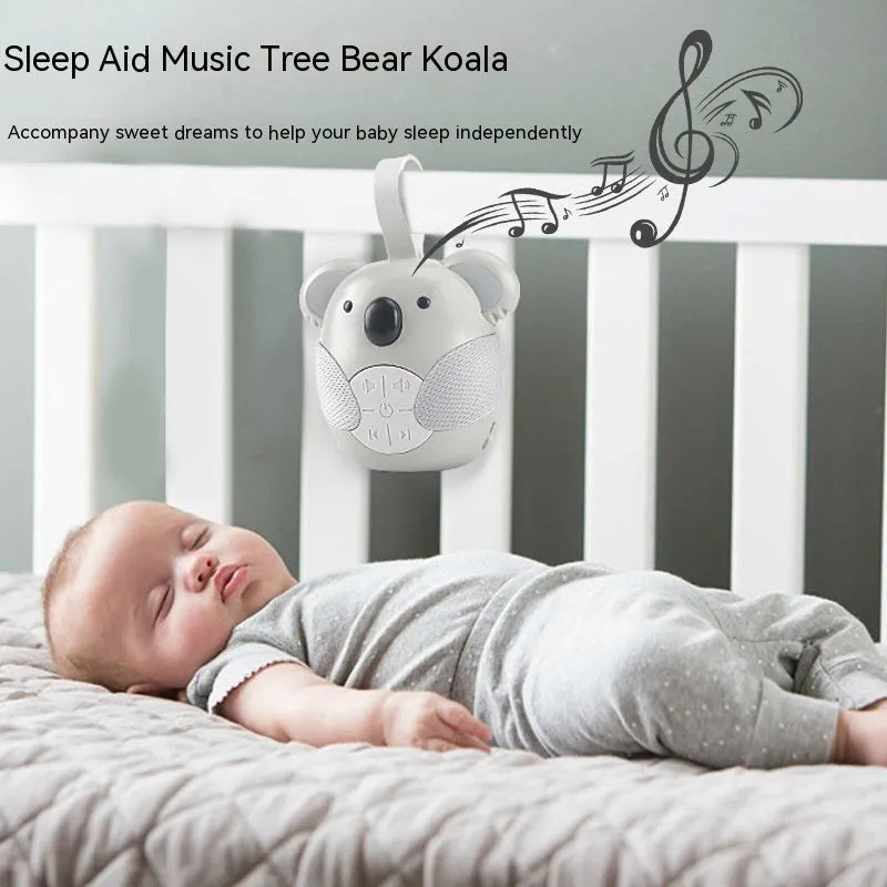 Koala-shaped infant white noise player toy in fox colour on a surface
