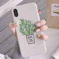 White silicone iPhone case with a detailed painted plant pattern on the back.