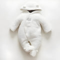 Newborn baby wearing a white cotton padded long sleeve romper jumpsuit