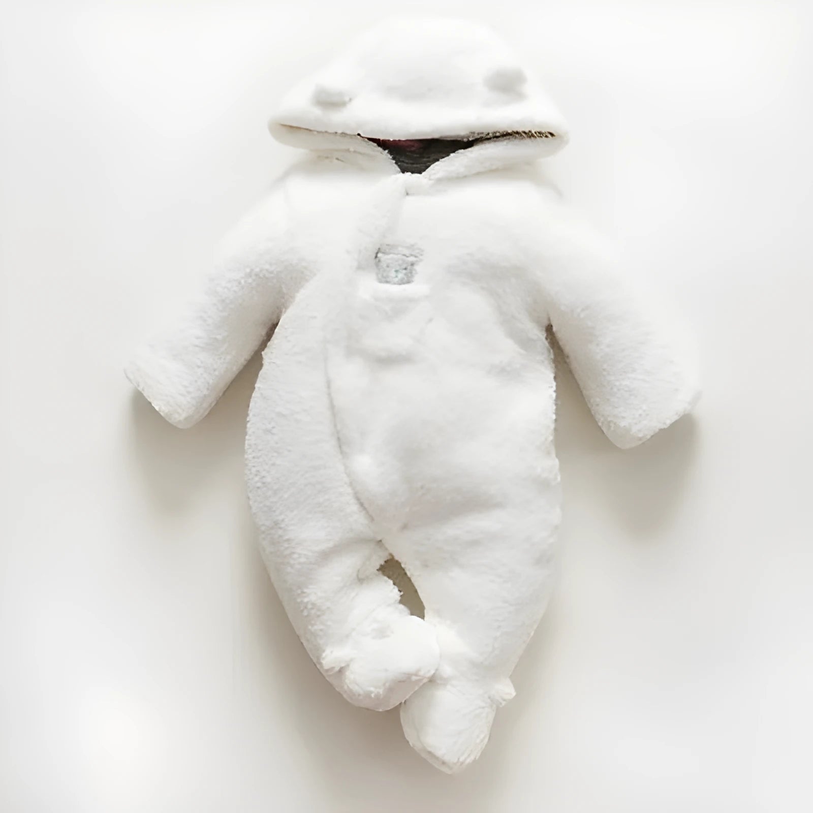 Newborn baby wearing a white cotton padded long sleeve romper jumpsuit
