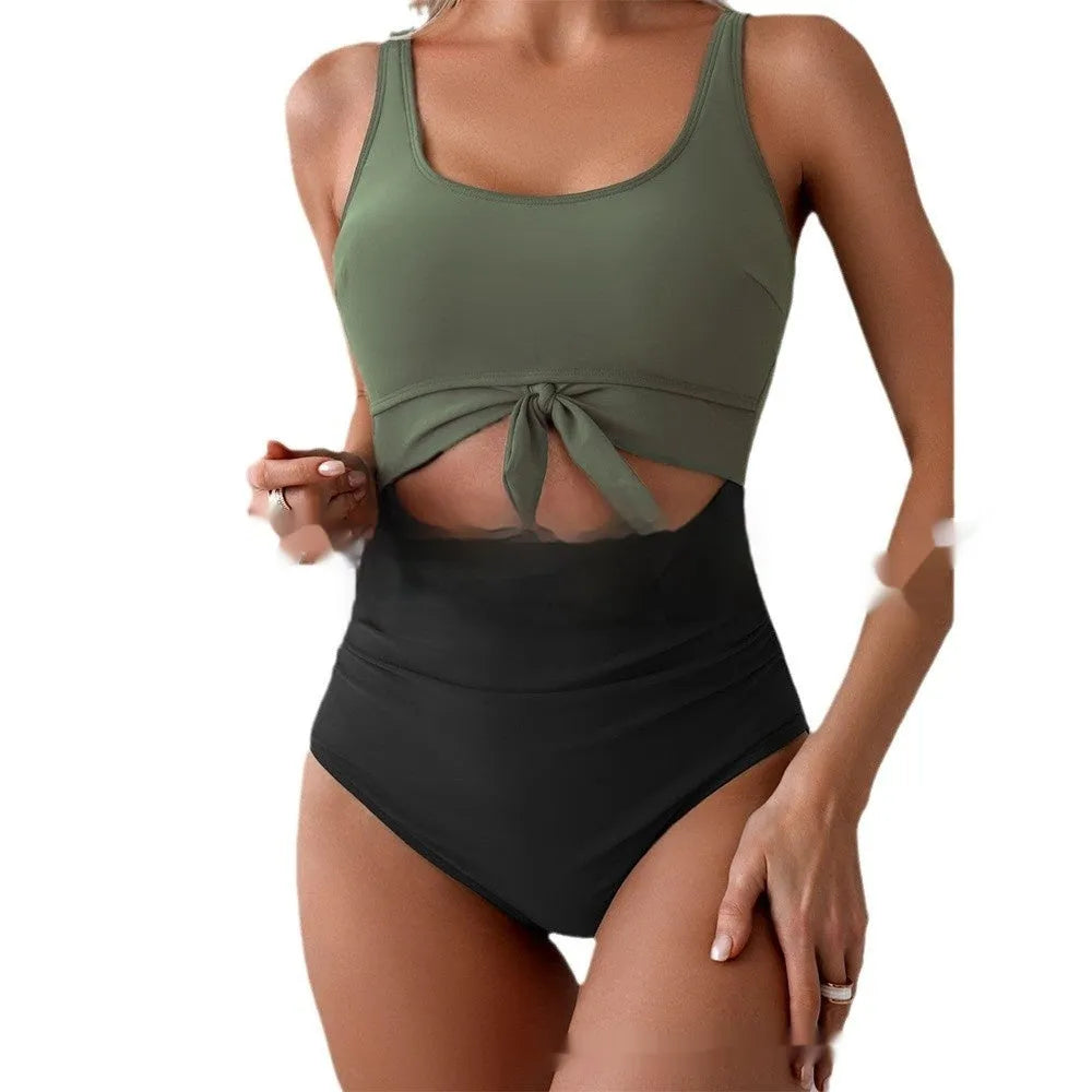 One-piece female swimsuit with contrast colour straps and covered belly in rose-red and black