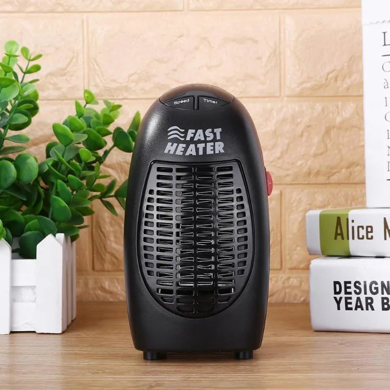 Black compact ceramic electric heater with digital display and rotating plug on a desk.