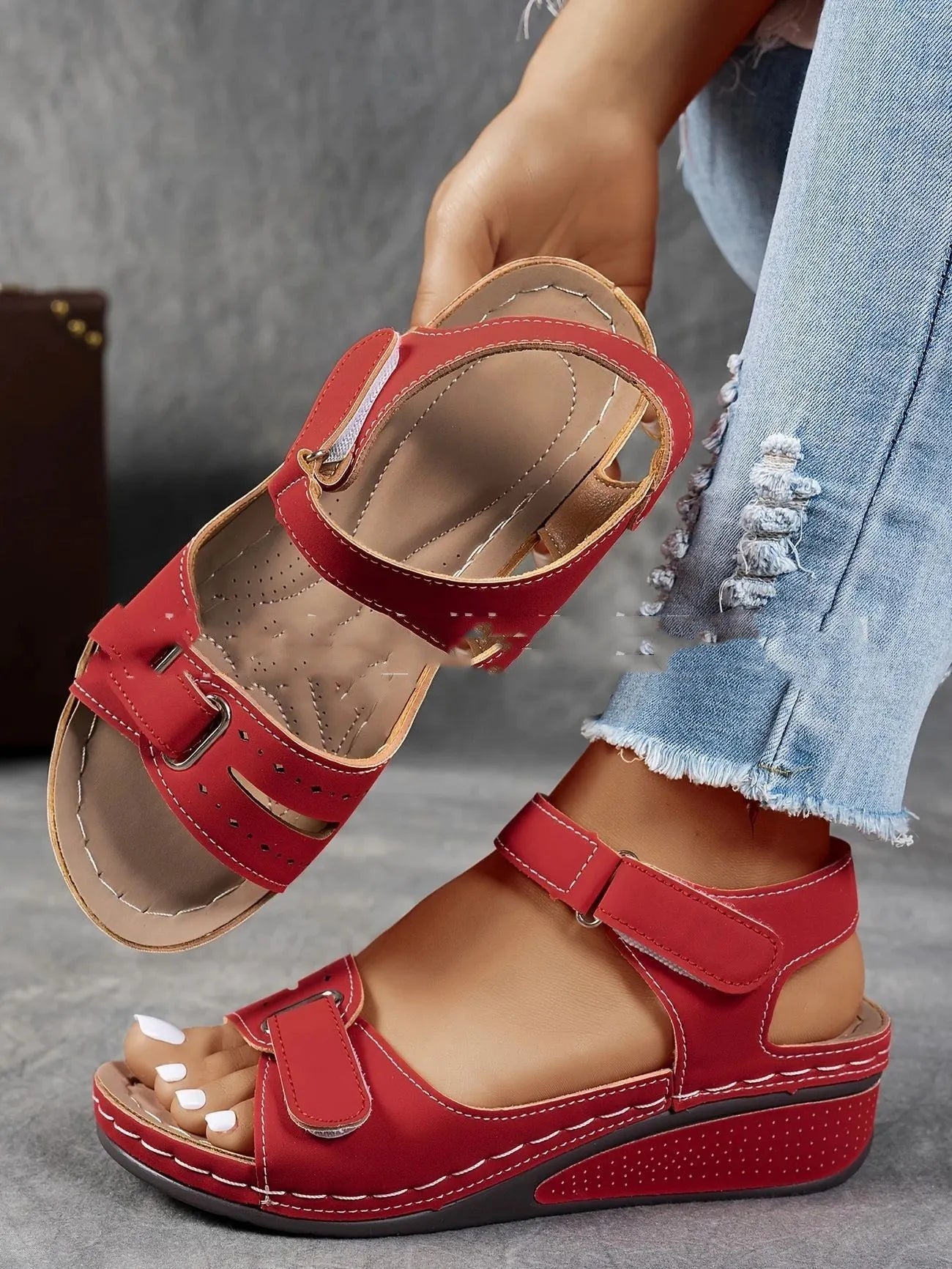 Women's beige thick-soled sandals with adjustable black Velcro straps on a white background.