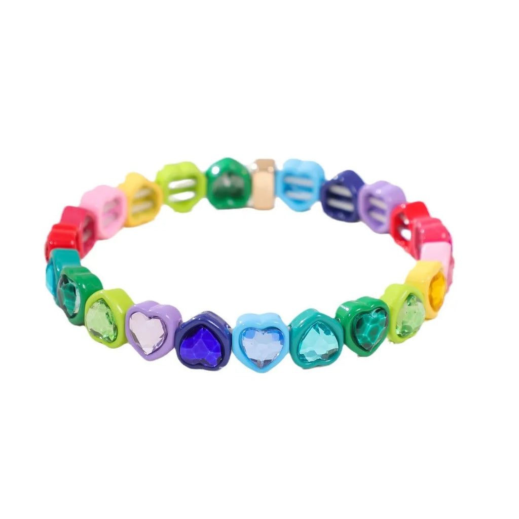 Colourful enamel heart-shaped pendant on a silver stretch bracelet.