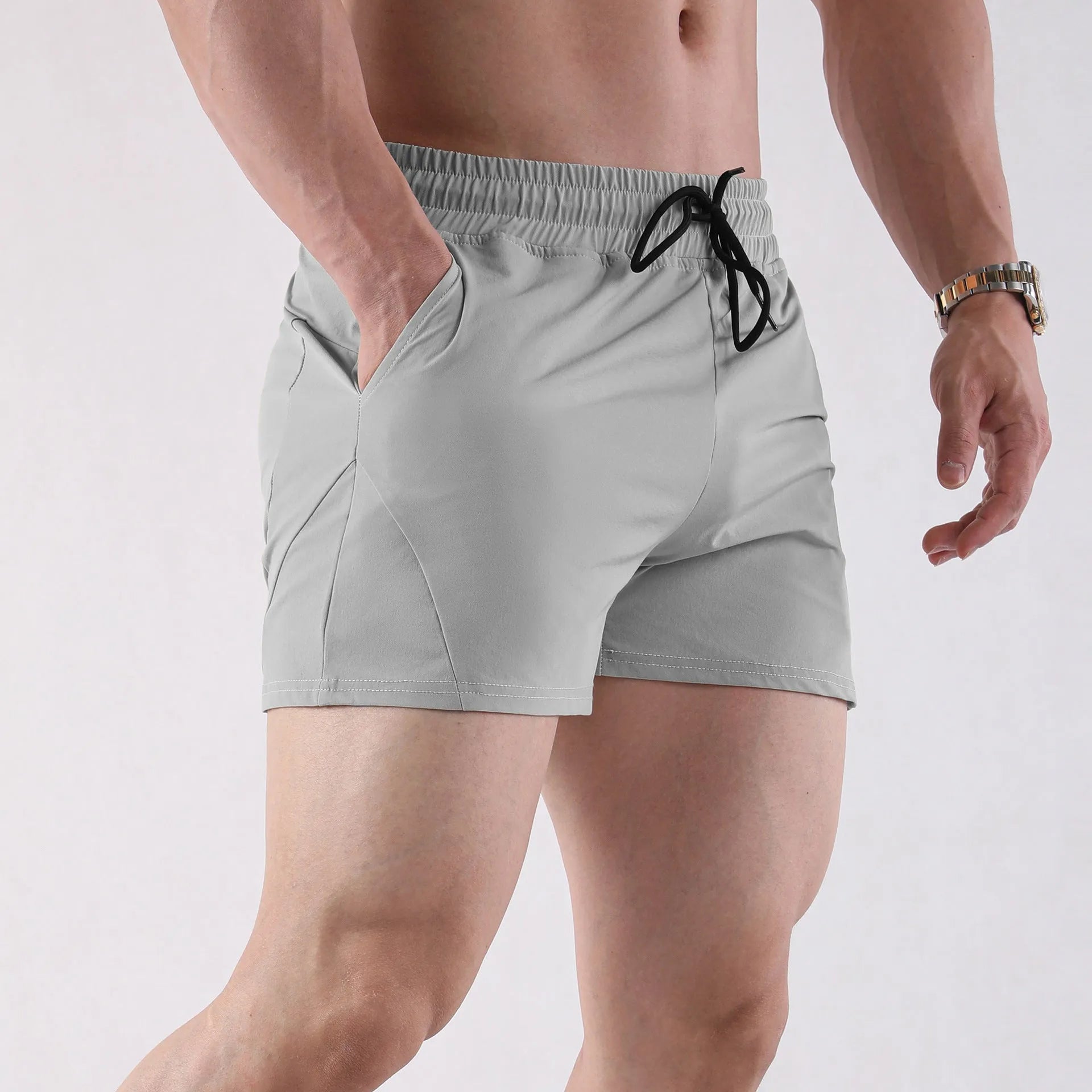Men's grey polyester basketball shorts with an elastic waistband, laid flat.