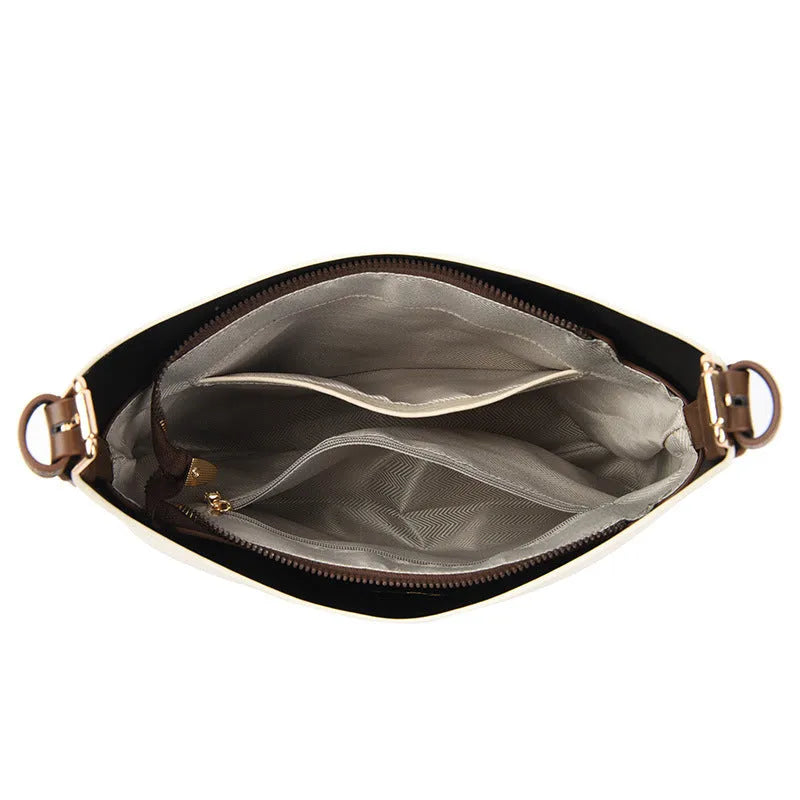 PU bucket bag in beige with contrast stitching, single shoulder strap, and open top showing internal organiser pockets.