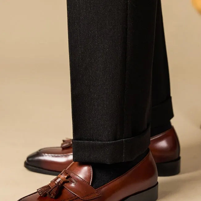 British-style leather tassel loafers in black or brown with polished uppers and traditional tassel detailing