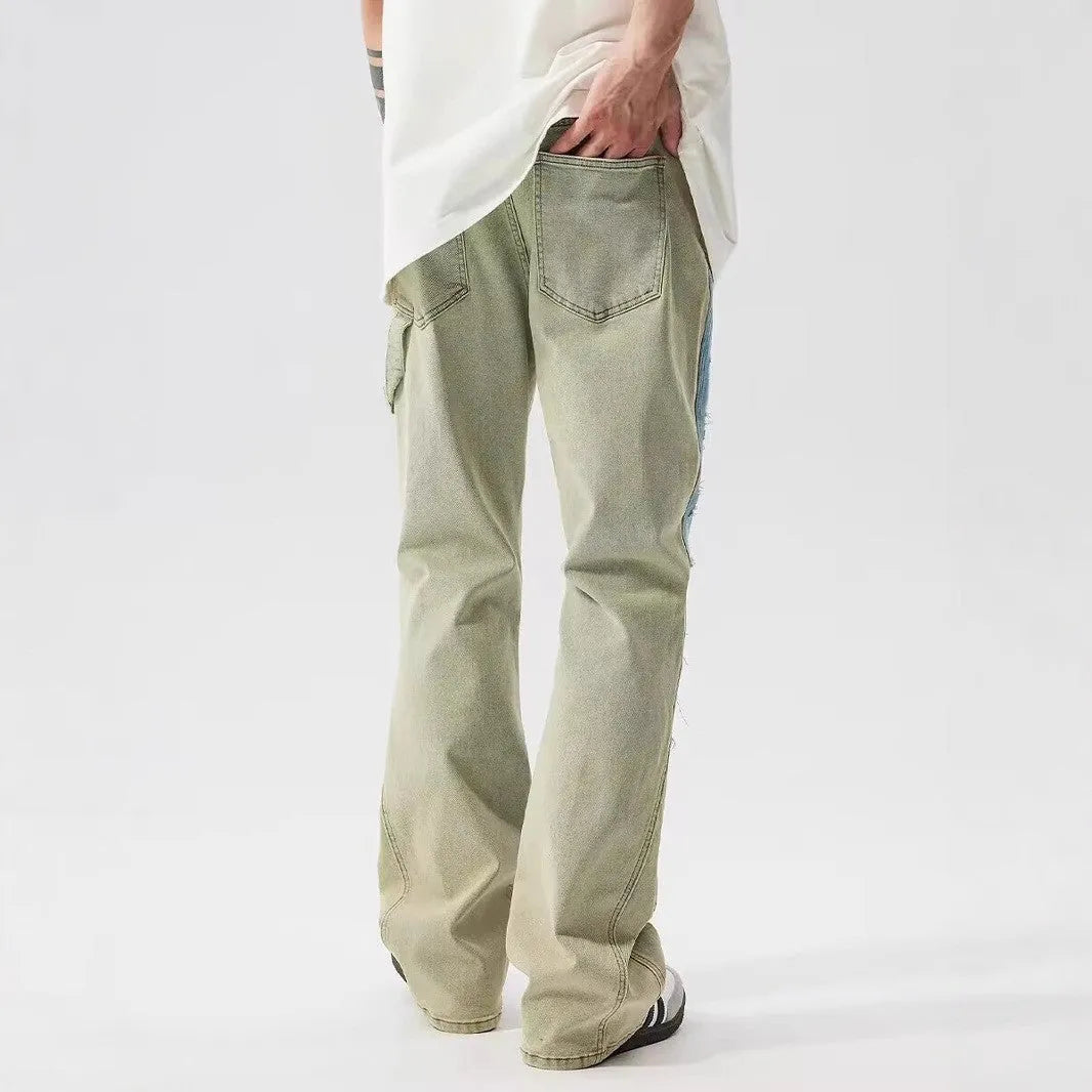 Yellow and blue retro patchwork jeans with a splash-ink damaged design on a mannequin.