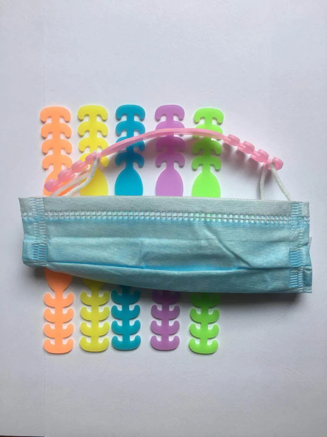 Pack of eight coloured silicone tool buckle straps on a workbench