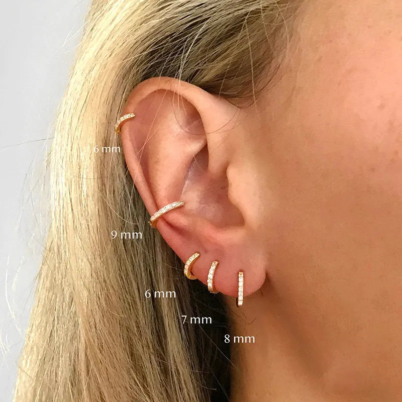 Geometric round perforated stud earrings in gold, rose gold, and silver colour on a white background.