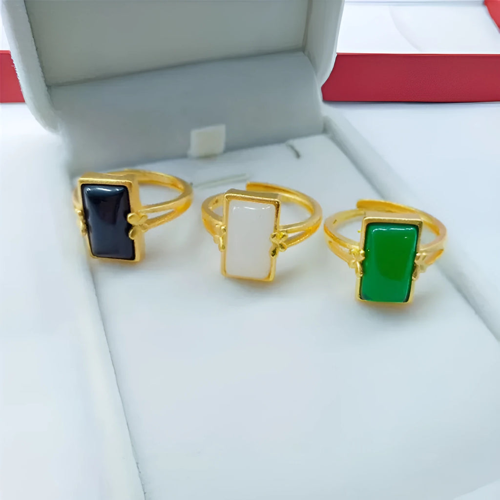 Gold-plated brass ring with an adjustable band and a central green gemstone in a national style.