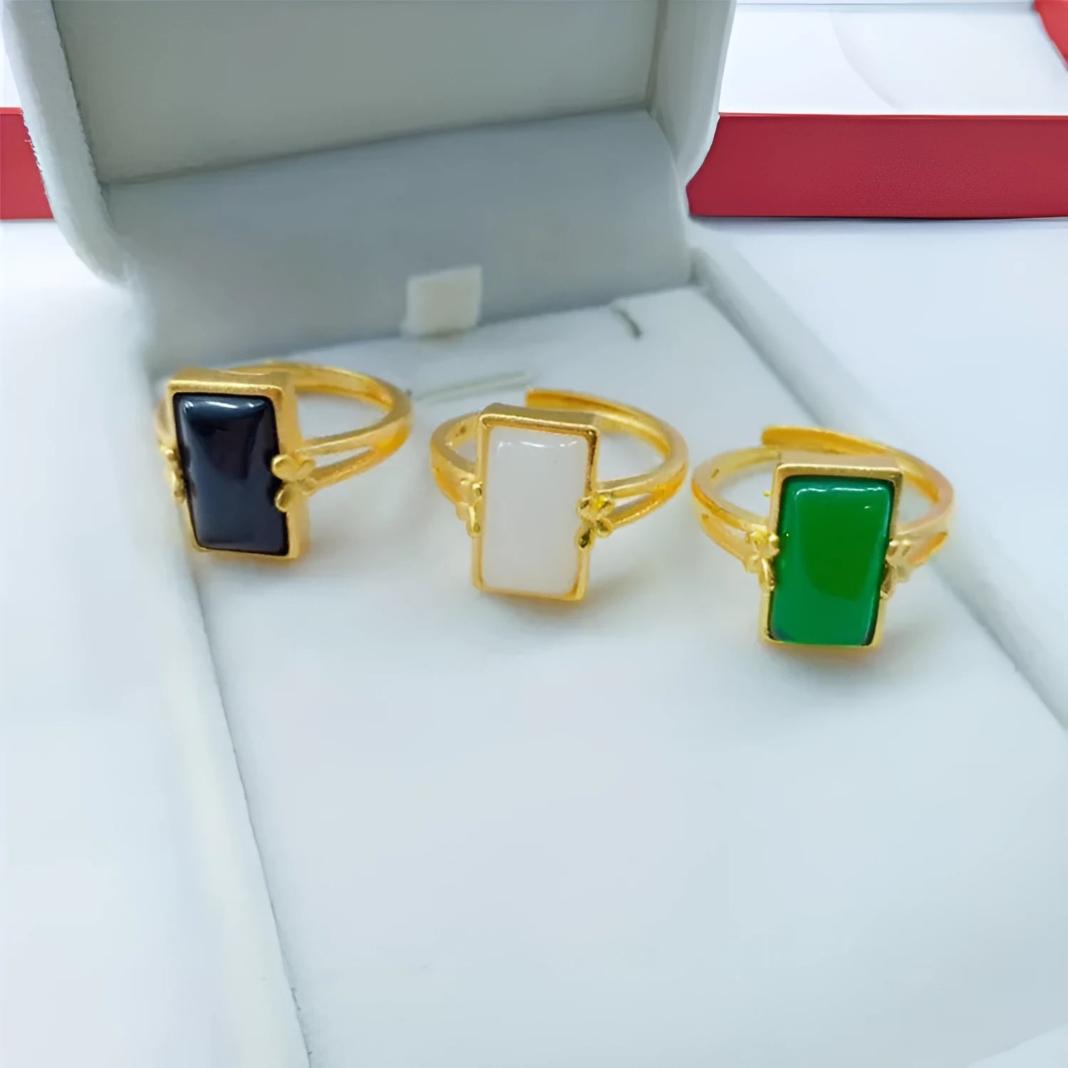 Gold-plated brass ring with an adjustable band and a central green gemstone in a national style.