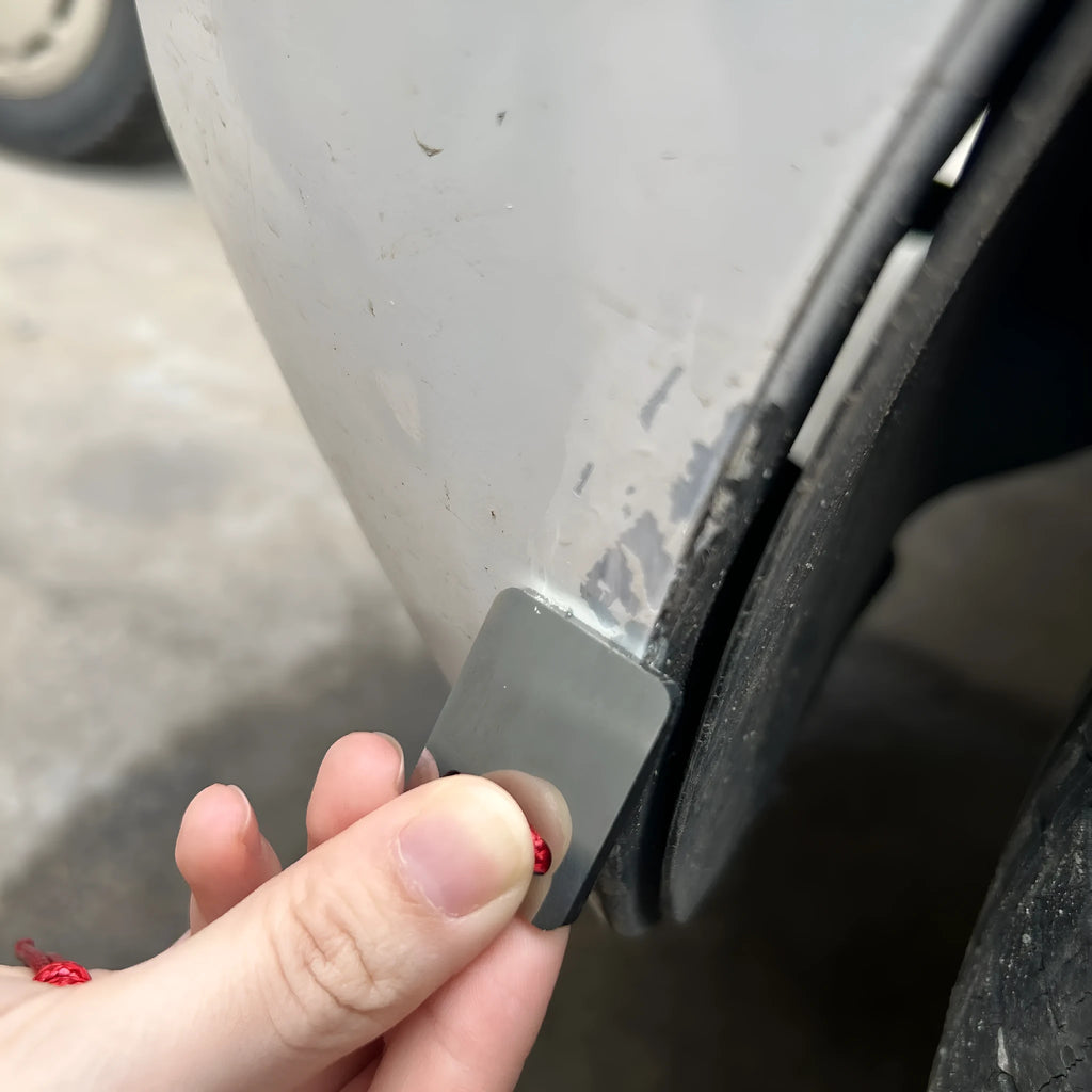Silver-coloured metal car paint repair scraper tool for vehicle scratch and dent touch-ups.