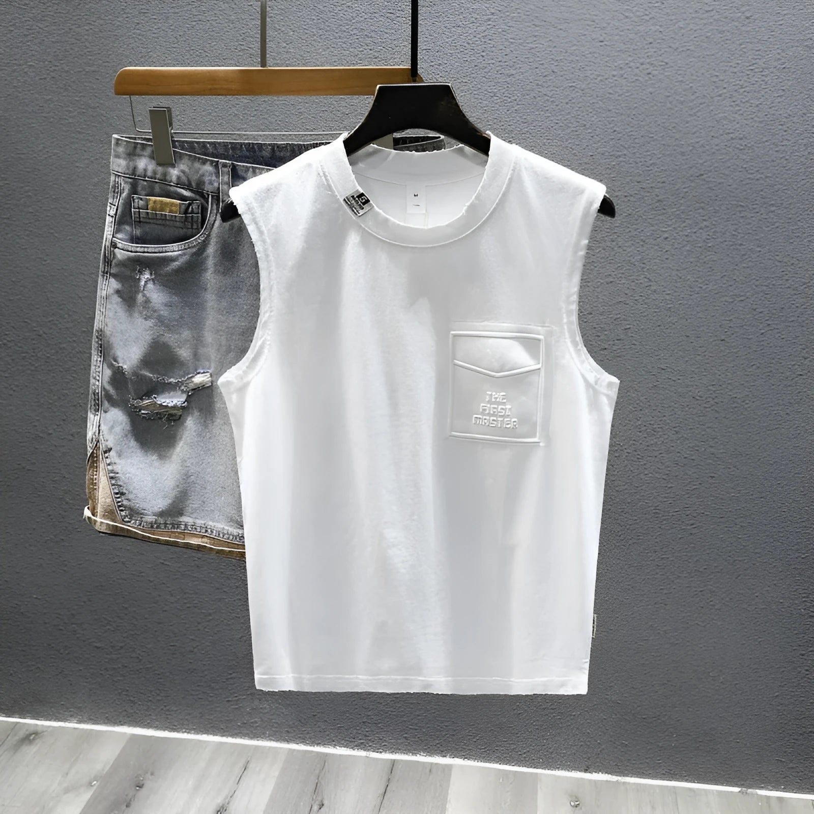 Men's solid black cotton sleeveless t-shirt with loose fit and straight hem on a white background.